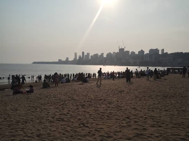 Families gather before sunset on Chowpatty beach in Mumbai