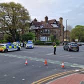 A number of police vehicles and officers pictured sealing off the scene at Otley Road, in Headingley, Leeds, following a serious incident.