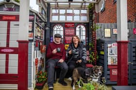 Train-mad couple Richard Cantrell and Katherine Siggins with dog Jess in the back garden at their home-made 'station'.