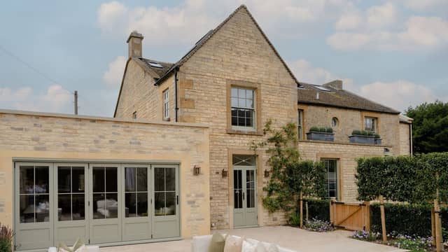The exterior is a classic Cotswolds house, made from the local stone