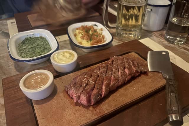 The flat iron steak is best served with a selection of sides and sauces.