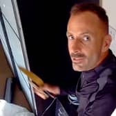 This was the moment arsonist, Martin Foley, spat in the face of a police officer as he was being rescued from a burning roof. 