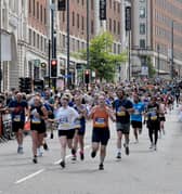 Crowds line The Headrow as runners near the finish of the Leeds 10K.
