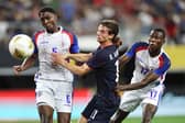 CLOSE TO GLORY: Leeds United's Brenden Aaronson, centre, with the USA.