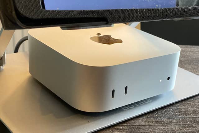 My Apple Mac mini M4 set up neatly under the monitor on my home office desk.