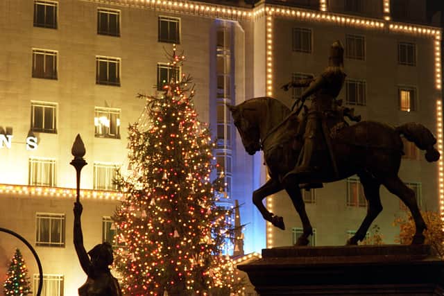 The Black Prince silhouetted against the Queens Hotel and the City Square Christmas Tree.