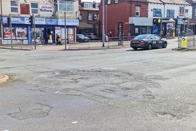 Damage to the road at the junction of Harehills Lane and Compton Road a year on from the riot.
