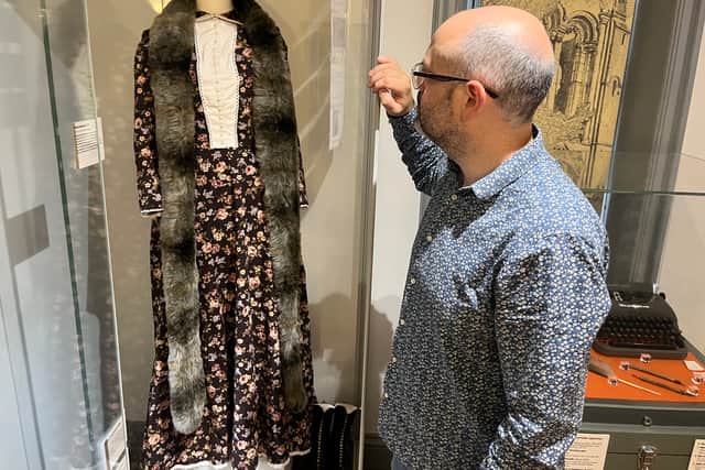 Curator Patrick Bourne with a dress created as part of theatre show and exhibition Corseted, which centred around the life and work of radical Leeds suffragist Alice Cliff Scatcherd.