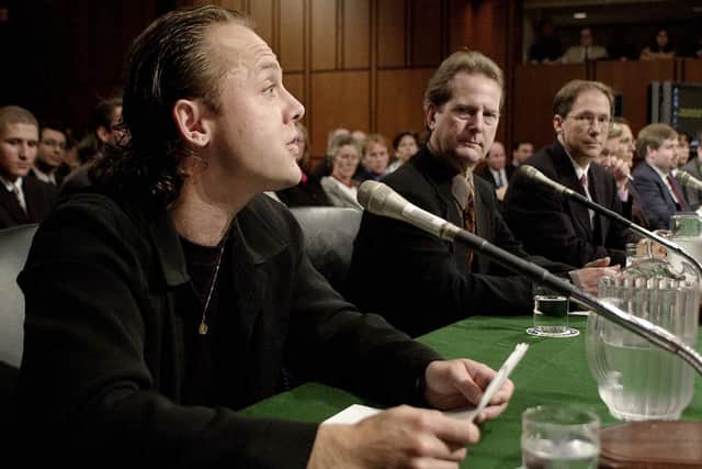 Drummer Lars Ulrich (L) of the hard rock band Metallica testifies before the US Senate Judiciary Committee on music on the Internet 11 July 2000, on Capitol Hill in Washington, DC as Roger McGuinn (C) of the band The Byrds and Hank Berry (R), CEO of Napster, look on. Ulrich testified that music is downloaded from online MP3 sites without legal rights.