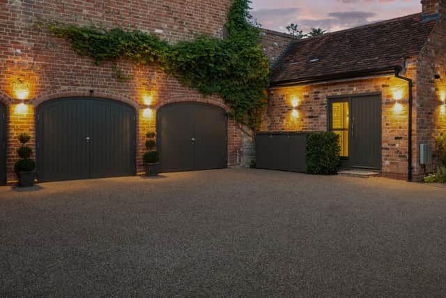 The outbuildings include a large garage and a detached annexe