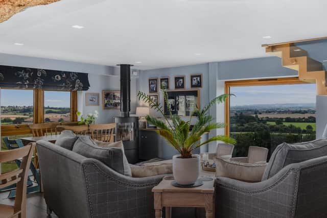Huge windows let light bathe each of the beautifully-furnished room