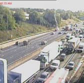 A blaze on the M62 has brought traffic to a halt - with pictures showing huge queues building on the westbound carriageway between Junction 27 (M621) and Junction 26 (M606).