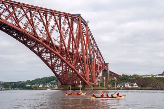 Crews from the Queensferry Rowing Club give an oar salute to the crew of ROW4MND at the Forth Bridge, near South Queensferry, Edinburgh.