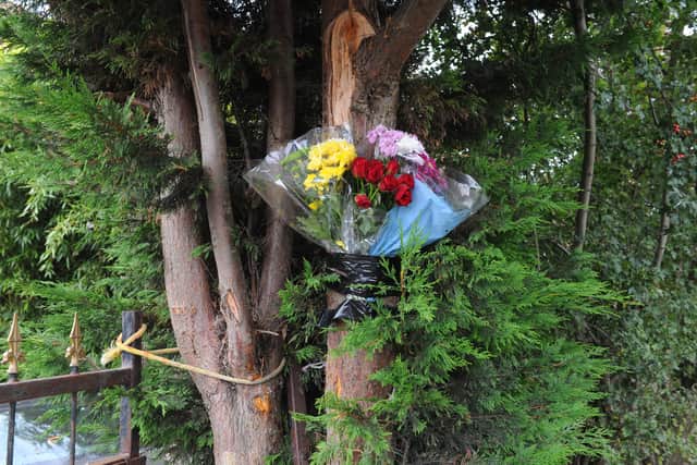 Flowers on the tree where a teenager died on Saturday morning.