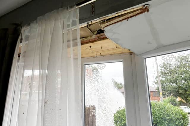The explosion was so powerful that part of the road went through the front bedroom window and water seeped through the roof tiles into the house