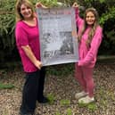 Sammi Shapero and Becky Joyce with the Damien Hirst poster which has been signed by the artist himself