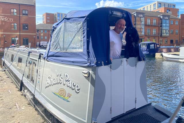 John Bailey has been living on a canal boat with his dog and partner for the last five years. He said he loves the lifestyle and seeing the "stunning" countryside.