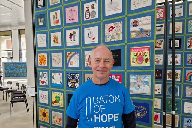 Steve Phillip with the Yorkshire Speak Their Name Quilt behind him.