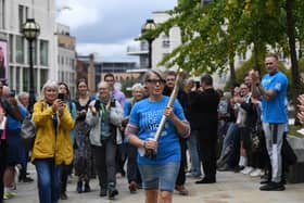 An emotional Caroline Litman carries the Baton of Hope, one of the UK's biggest suicide prevention initiatives, into Millennium Square