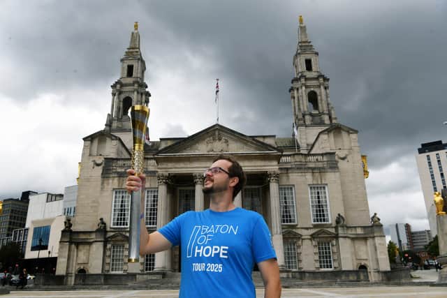 Mathew Pearson with the Baton of Hope, before setting off from Millennium Square