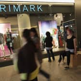 Shoppers walk past a Primark clothing store. The retailer's parent company has warned large UK stores could be under 'pressure' from tax changes (Photo: Sean Gallup/Getty Images)