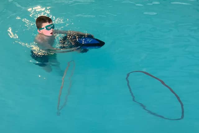 Eddie Morton tries a sea scooter in Ladram Bay holiday park's swimming pool