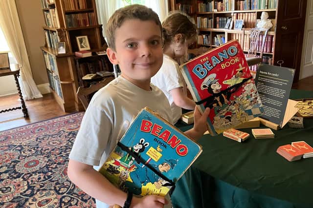 Eddie Morton is delighted at being allowed to read old copies of the Beano at Killerton House in Devon, during a stay at Ladram Bay holiday park