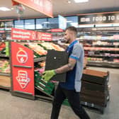 Colleagues at an Aldi store restock the shelves. The supermarket is opening applications for 500 paid apprenticeship roles across the UK (Photo: Christopher Furlong/Getty Images)