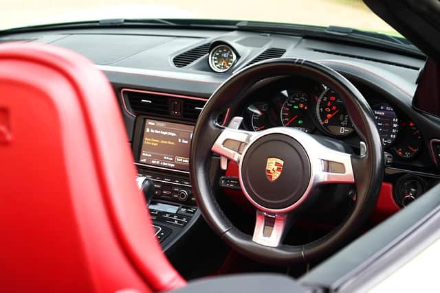 Striking red leather lifts the interior