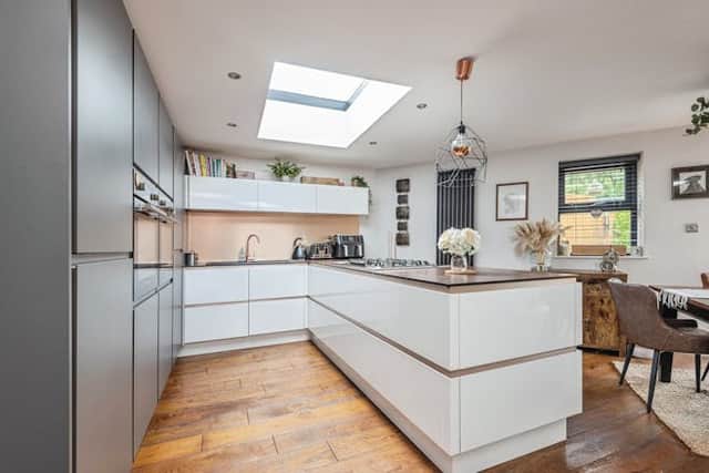The kitchen is modern and spacious
