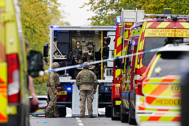 Members of the army with a bomb disposal robot at the scene of the incident