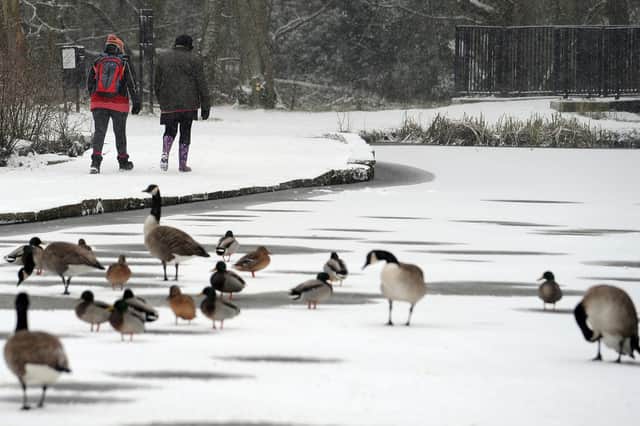 Stock image of people walk through snow in the UK, 2013.