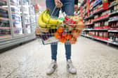 A woman holds a shopping basket of groceries. Asda is opening nine new Express convenience stores this week across London and the UK (Photo: Matthew Horwood/Getty Images)