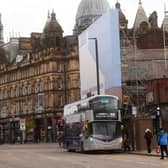 Stock image of bus picking up passengers outside the Leeds Corn Exchange.