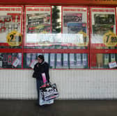A woman waits outside a branch of Poundstretcher near Lewisham high street in London in 2012. The retailer is giving away free £10 vouchers to shoppers this weekend across the UK (Photo: Oli Scarff/Getty Images)