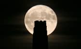 A full beaver moon rising behind St Michael's Tower on Glastonbury Tor in 2017