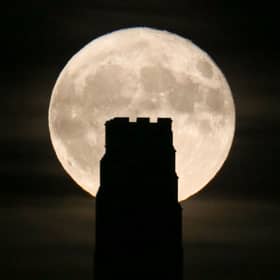 A full beaver moon rising behind St Michael's Tower on Glastonbury Tor in 2017