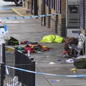 Forensic investigators at Huntingdon train station in Cambridgeshire, after a number of people were stabbed on a train on Saturday. 