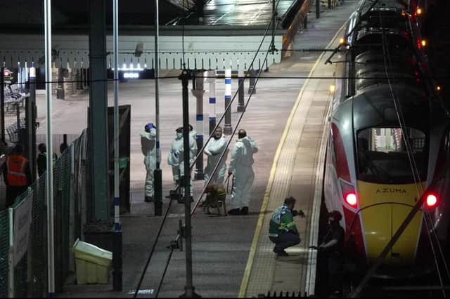 Forensic investigators on the platform at Huntingdon station in Cambridgeshire, after a number of people were stabbed on a train