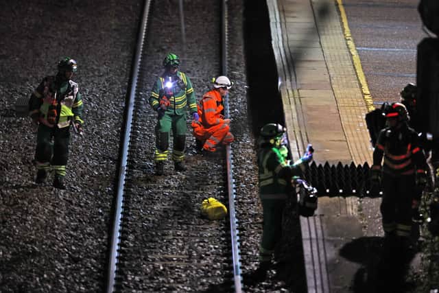 Emergency responders on the tracks by the train at Huntingdon station in Cambridgeshire, after a number of people were stabbed.