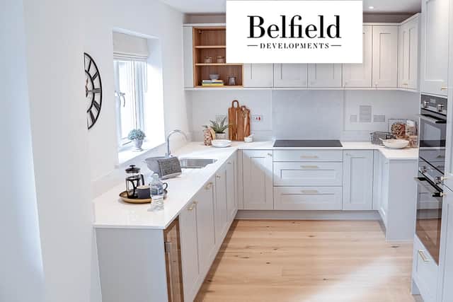 The stylish kitchen overlooks a wraparound garden