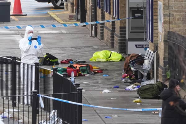 Forensic investigators at Huntingdon train station in Cambridgeshire, after a number of people were stabbed on a train on Saturday.