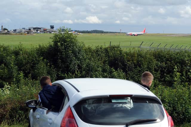 Youngsters plane spotting at Leeds Bradford Airport from Cemetery Road in Yeadon.
