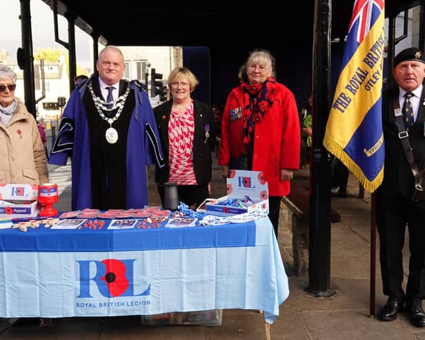 Shirley Ramsden has been presented with the first poppy,  in memory of her son Lance Corporal David Ramsden, as the Otley branch of the Royal British Legion opened its annual Remembrance fundraising