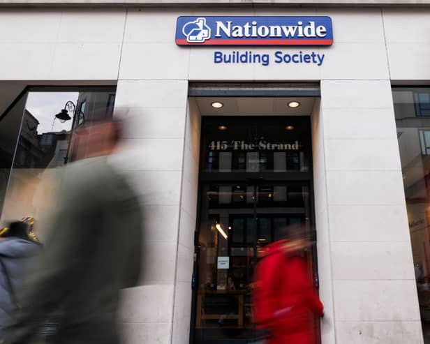 Members of the public walk past the Nationwide Building Society in London. Nationwide has pledged to keep all 696 of its branches, including Virgin Money locations, open until at least 2030 (Photo: Dan Kitwood/Getty Images)
