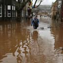 A man wades through floodwater after rivers burst their banks across the Calder Valley on Boxing Day 2015. 