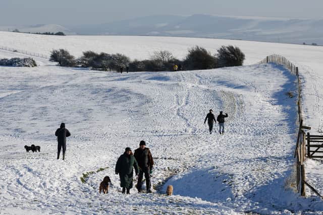 Walkers enjoy the snow at Ditchling Beacon in January 2025. Met Office snow and ice warnings are predicting dangerous travel conditions across the UK (Photo: Dan Kitwood/Getty Images)