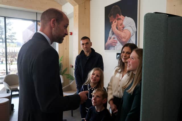 The Prince of Wales speaks with Lindsey Burrow, wife of the late rugby league player Rob Burrow, and their children Macy, Maya and Jackson, as rugby union coach Kevin Sinfield, who has raised more than 10 million pounds for motor neurone disease charities since 2019 stands nearby