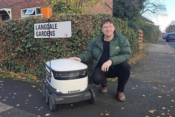 Councillor Jonathan Pryor pictured with one of the Starship robots ahead of the roll-out next month. 