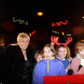 Actress Liz Dawn, better known as Coronation Street's Vera Duckworth, pictured with local school children after switching on the Christmas lights in December 1995.